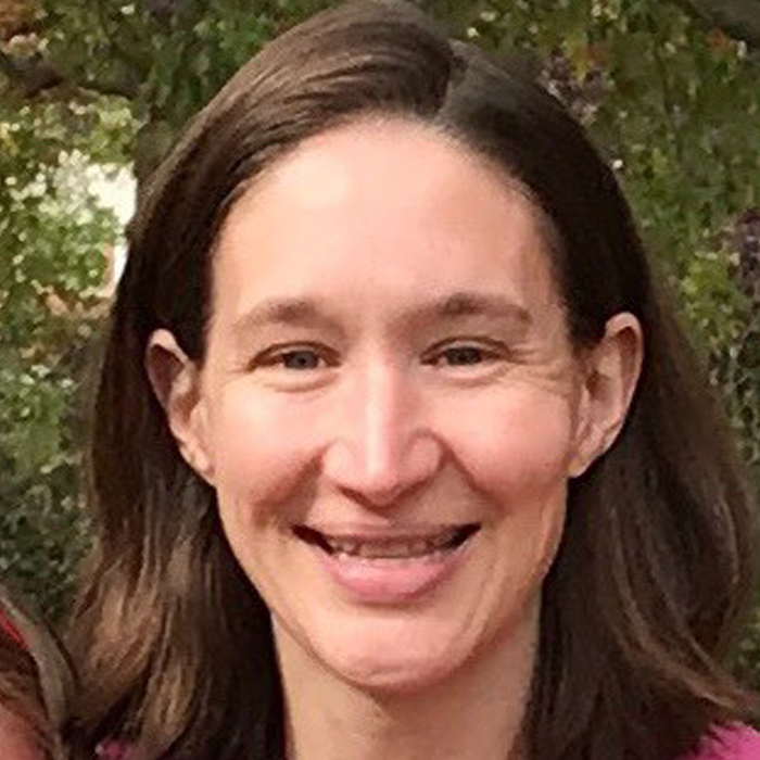 A woman with brown hair smiling