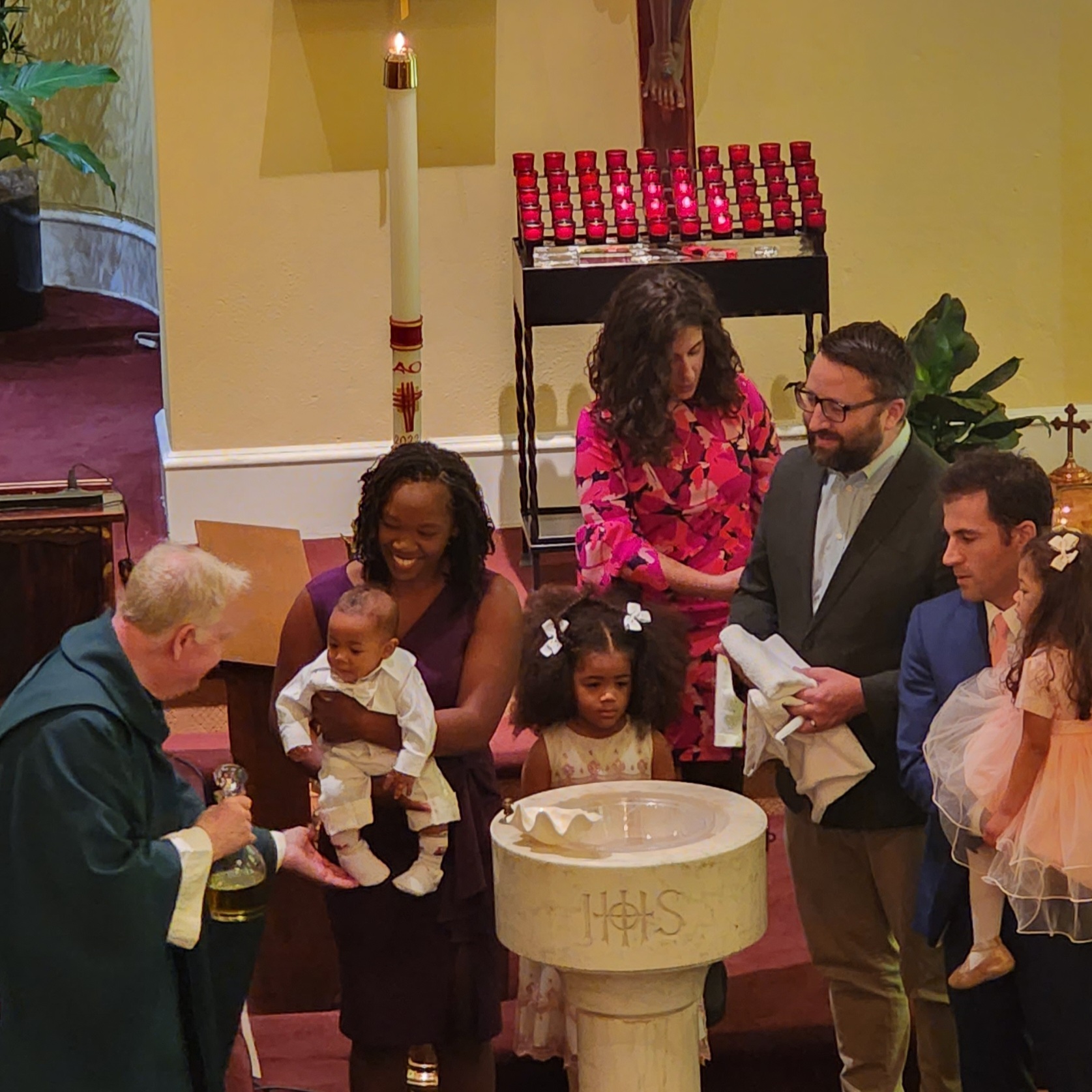 Priest is baptizing a baby